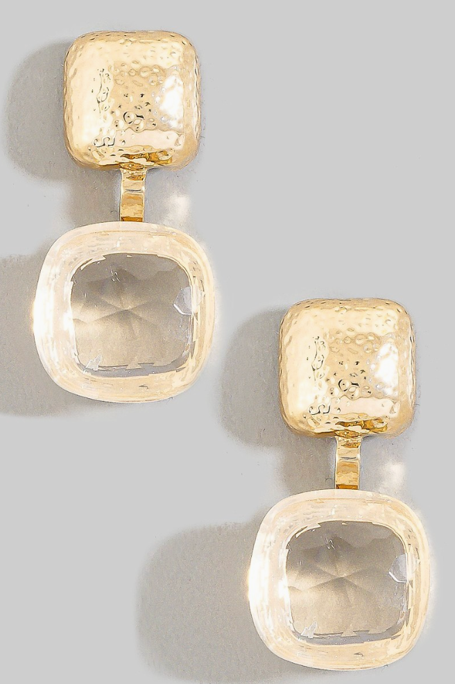 Gold earrings with square designs on a light gray background