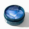 Patchology eye gel container with blue gel and patches on a white background
