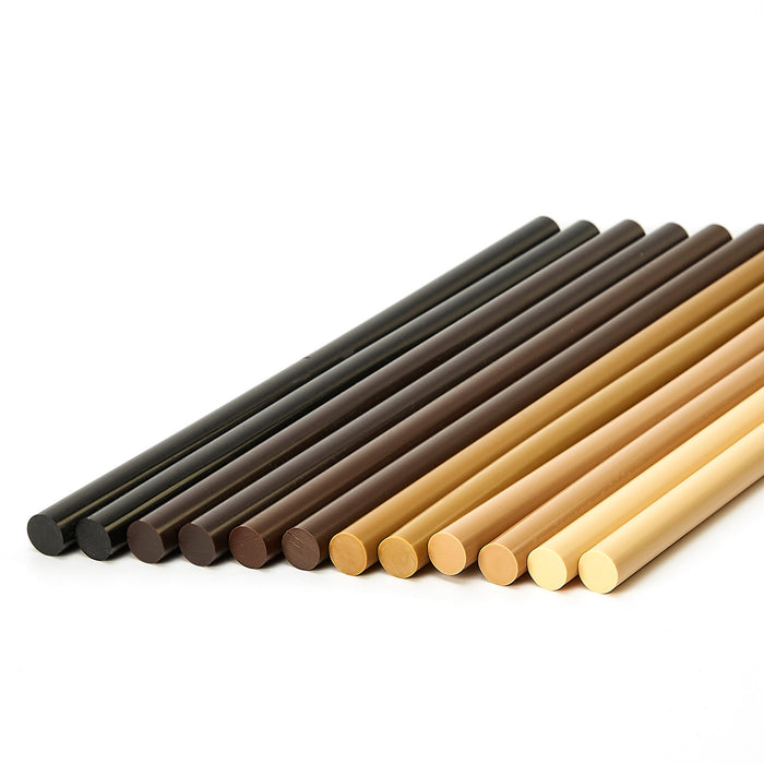 Assorted Knottec 7713 polyamide hot glue sticks displayed in multiple wood-tone colors for filling knots and defects by Power Adhesives.