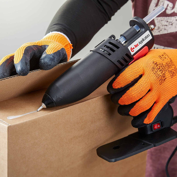 Tec 806 hot melt glue gun applying adhesive to corrugated cardboard for packaging and box assembly tasks