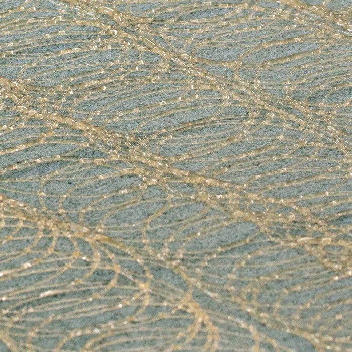 High-detail image of hot melt spray adhesive pattern on foam substrate used in packaging and fabrication.