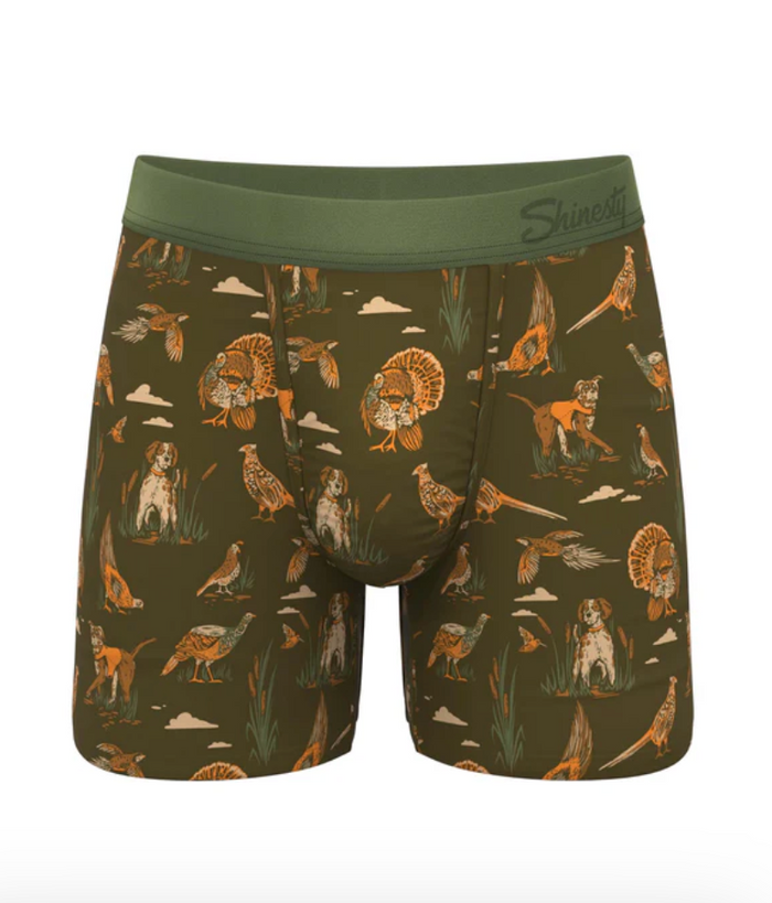 Green boxer briefs with nature-themed print on a white background