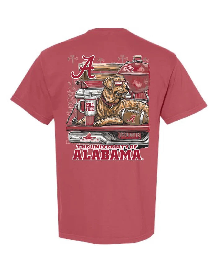 A red short-sleeve t-shirt with a large graphic print on the back featuring a bulldog in a pickup truck with 'The University of Alabama' text and the Alabama Crimson Tide branding.