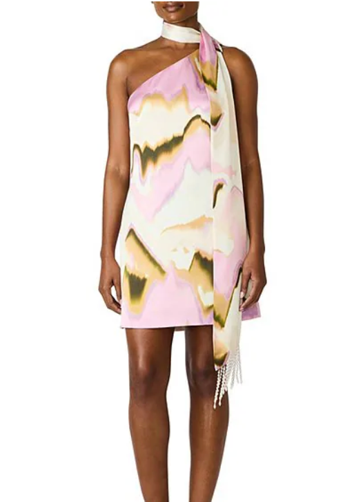 Woman wearing a floral one-shoulder dress with a white background