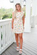 Woman wearing a floral dress on a white porch