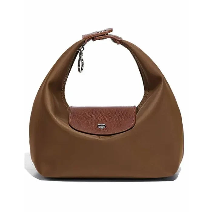 A brown slouchy shoulder bag with a textured brown leather front flap and a top handle, shown on a plain white background.