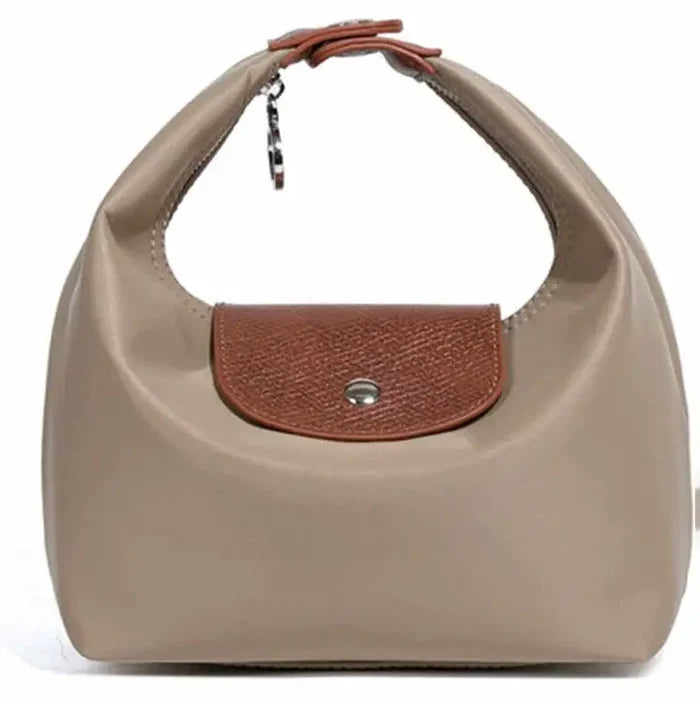 A taupe leather shoulder bag with a brown textured leather flap and a silver snap button closure, shown against a plain white background.