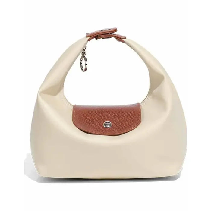 Beige handbag with brown flap on a white background