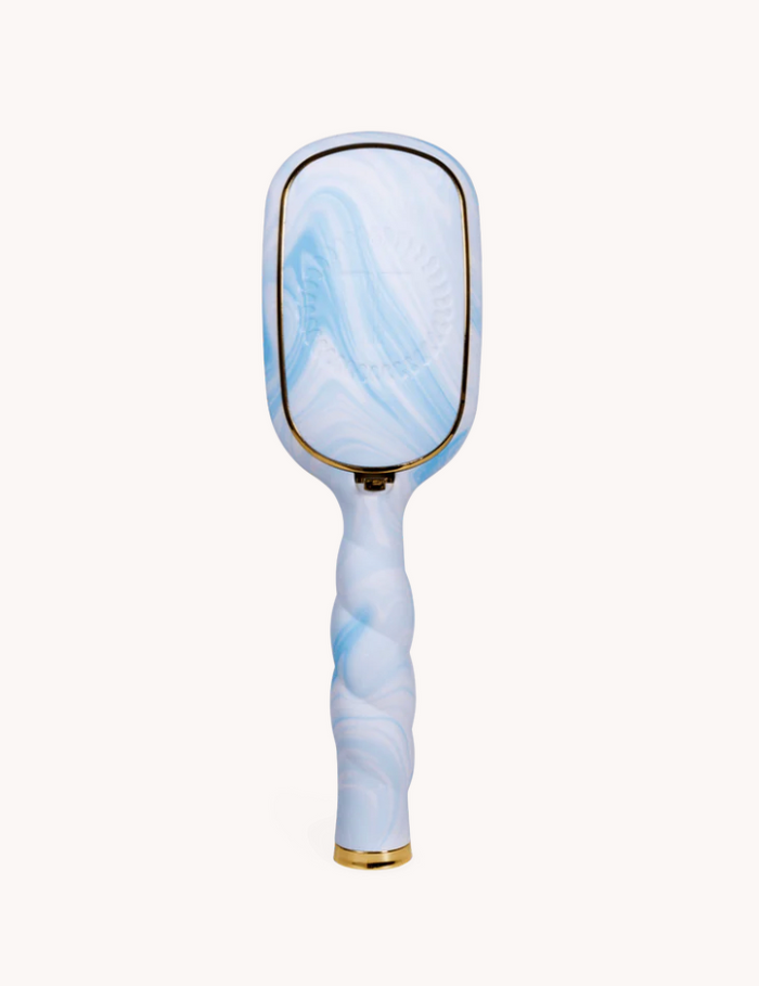 Marbled blue and white hairbrush on a white background