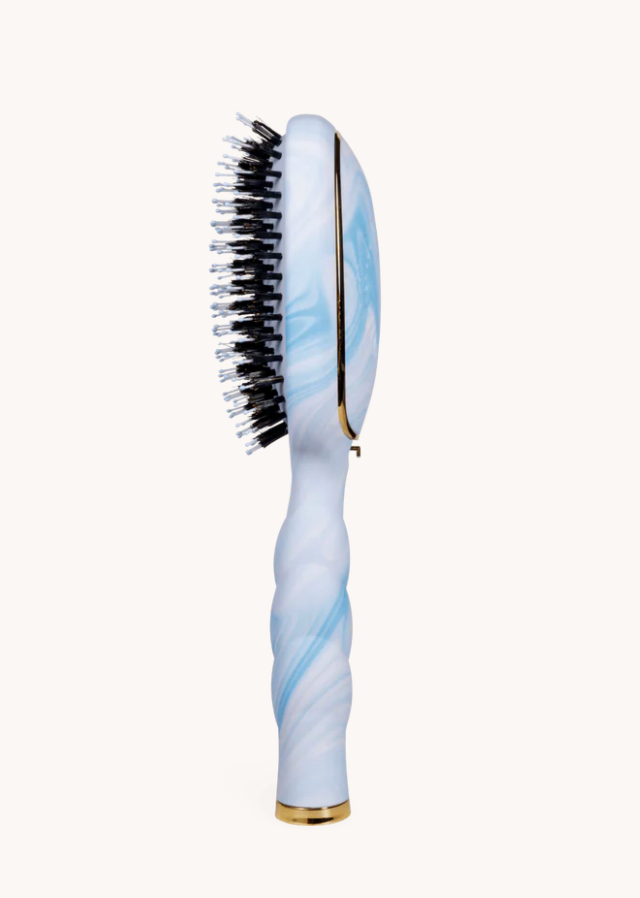 Hairbrush with blue and white handle on a white background