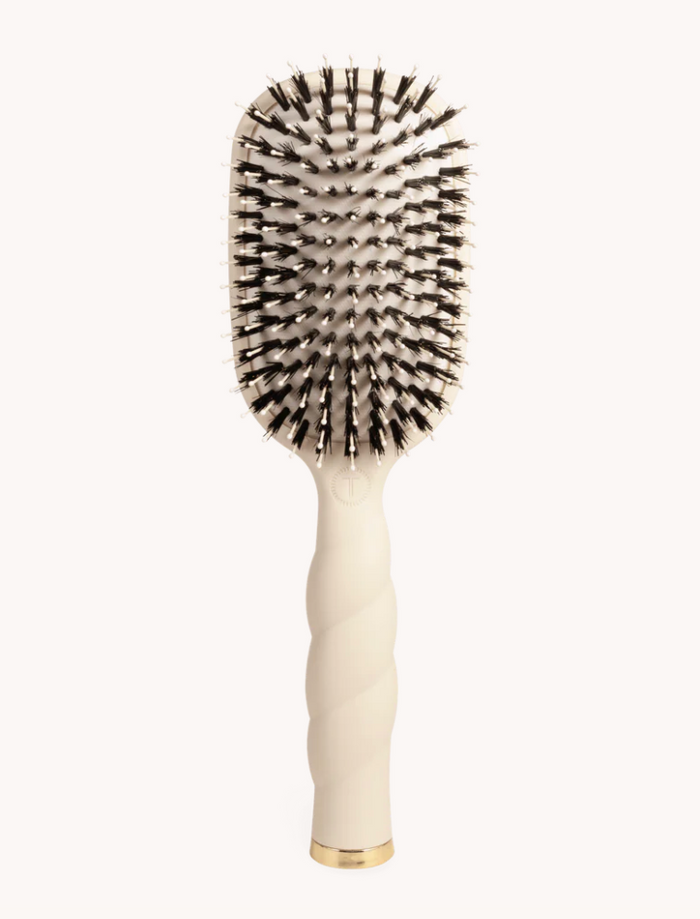 Black hairbrush with bristle head on a white background