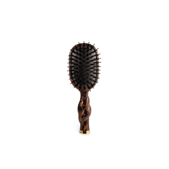 Hairbrush with tortoiseshell handle on a white background