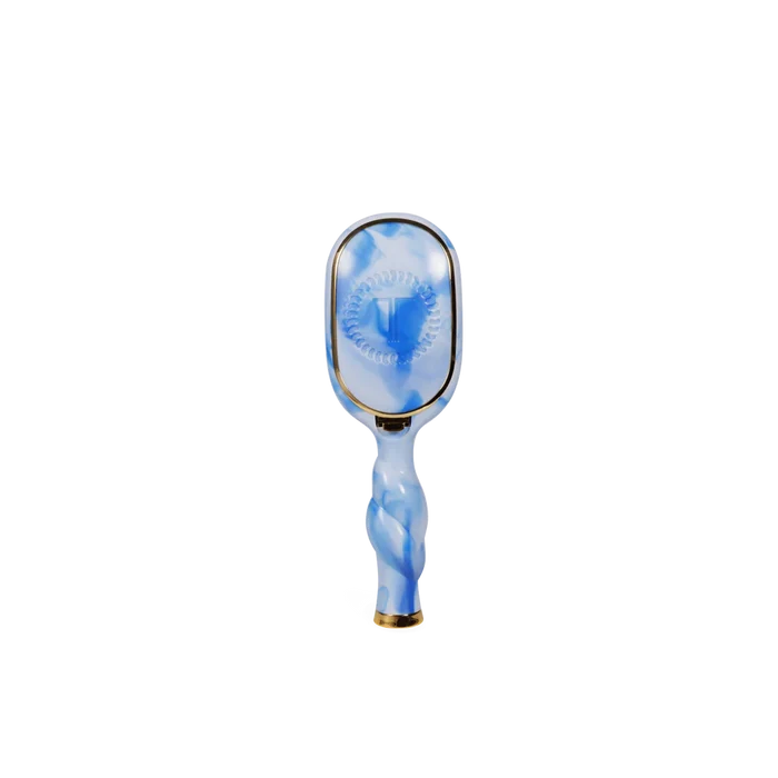 Blue and white hairbrush on a white background