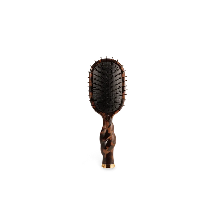 Hairbrush with tortoiseshell handle on a white background
