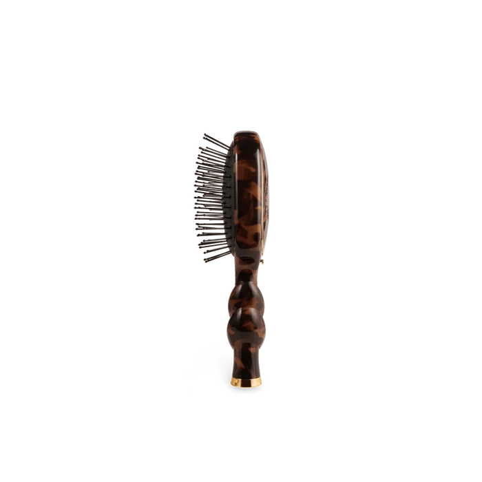 Hairbrush with tortoiseshell handle on a white background