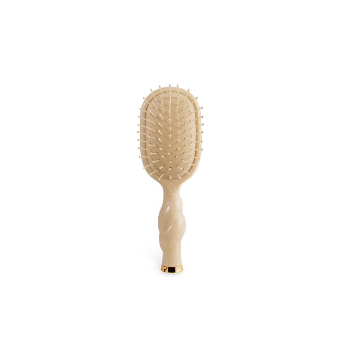 Beige paddle hairbrush on a white background
