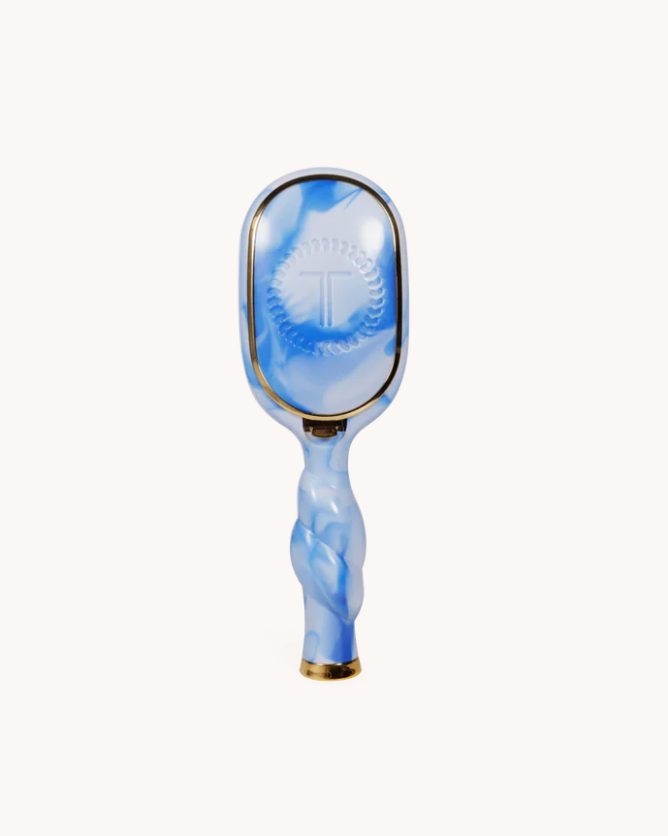 Blue marbled paddle with gold accents on a white background