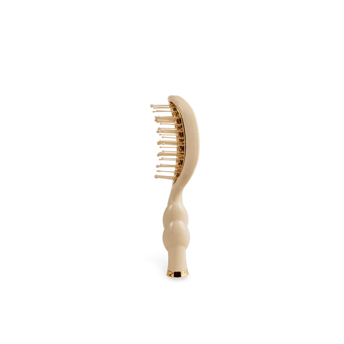 Beige hairbrush on a white background