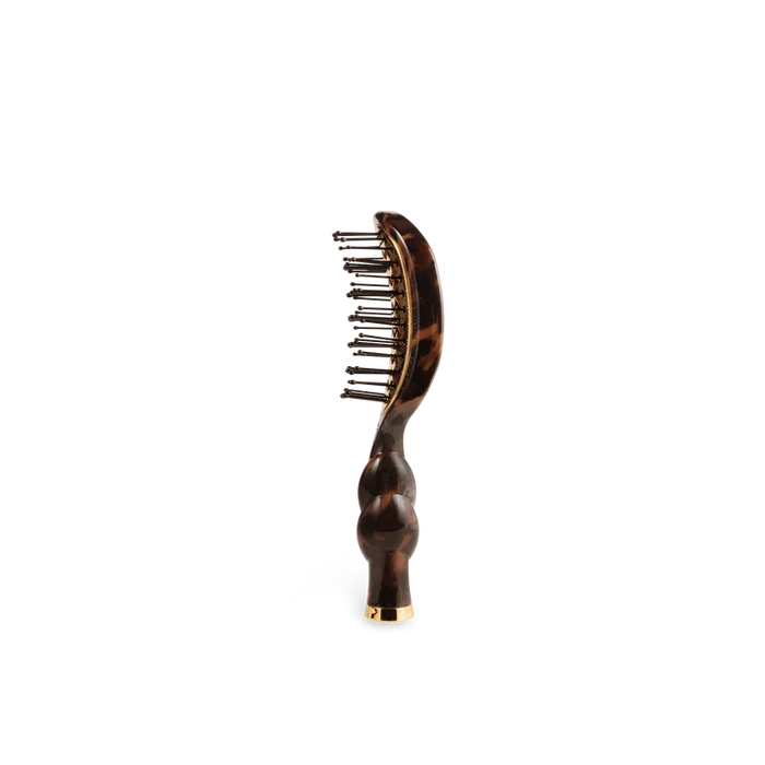 Hairbrush with tortoiseshell handle on a white background