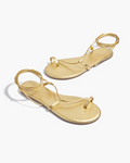 Pair of gold sandals on a white background
