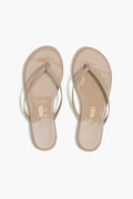 Pair of beige sandals with 'Tkees' branding on a white background
