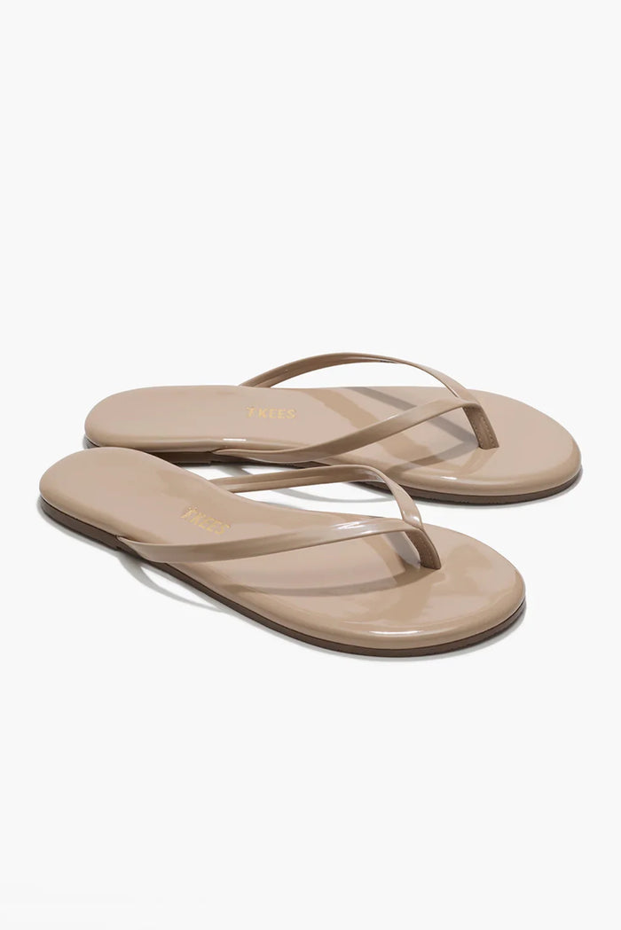Pair of beige sandals on a white background