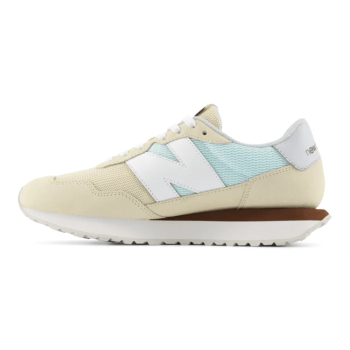 Beige sneaker with a light blue stripe and white accents on a white background