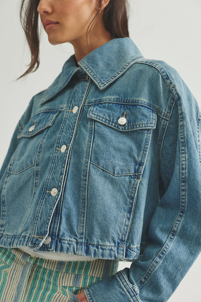 woman wearing a medium wash jean jacket