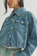 woman wearing a medium wash jean jacket