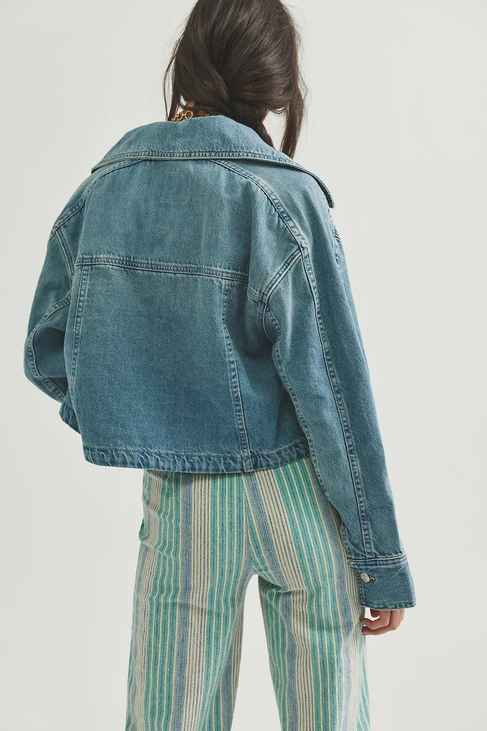 woman wearing a medium wash jean jacket