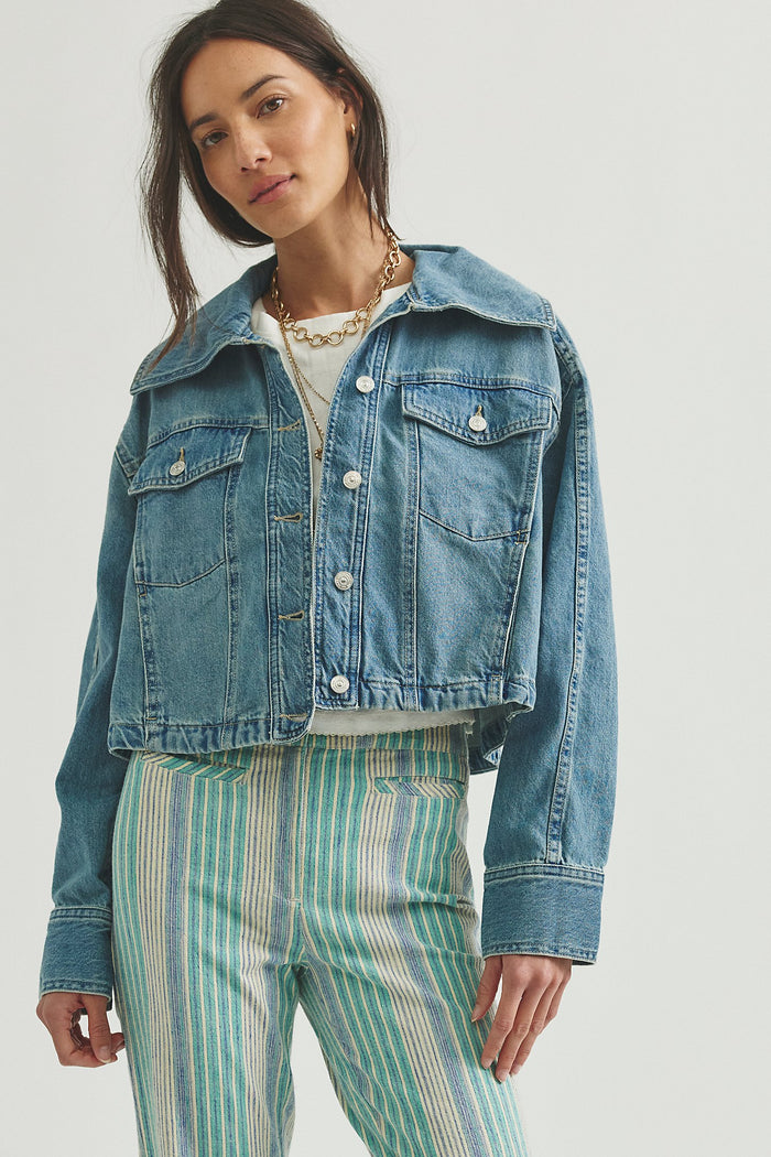 woman wearing a medium wash jean jacket