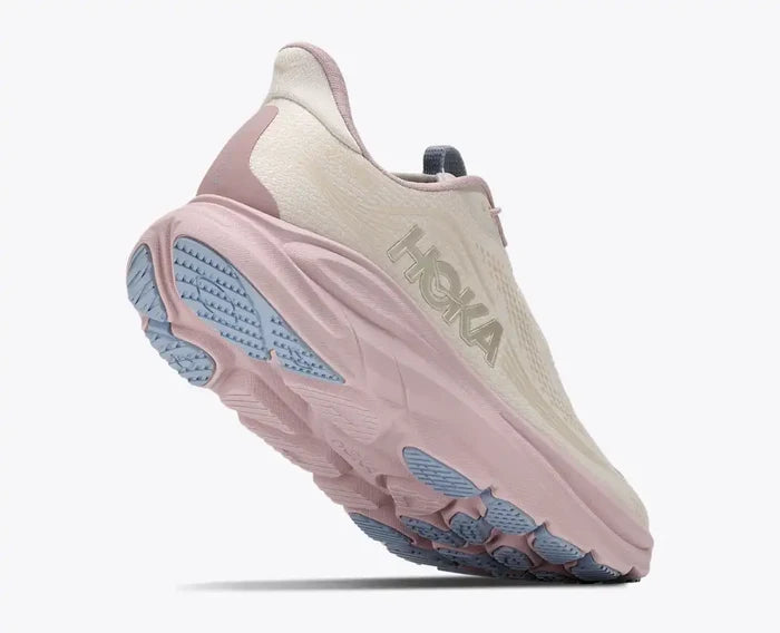 Pink running shoe with blue sole on a white background
