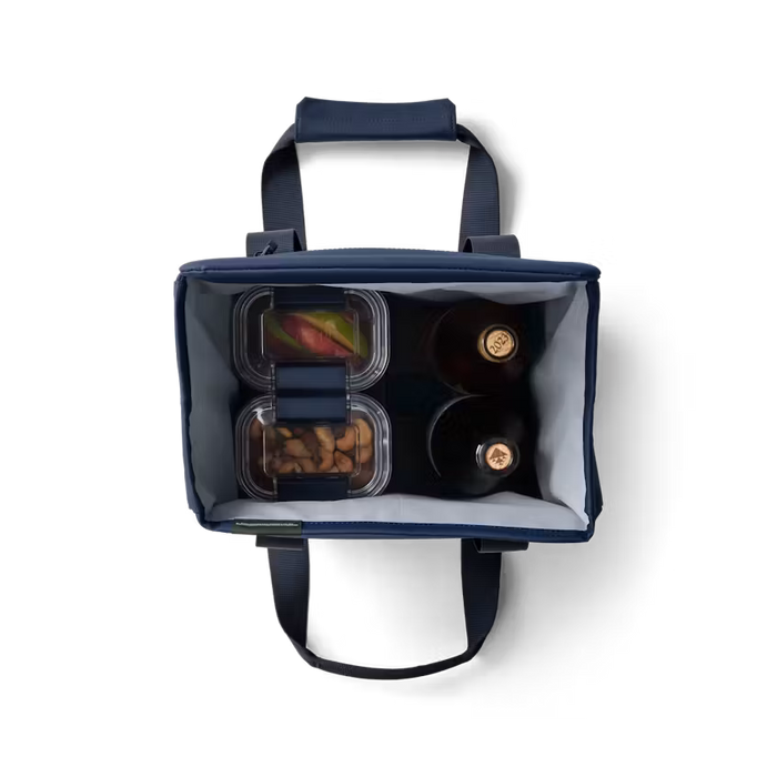 Navy blue cooler bag with food containers on a white background