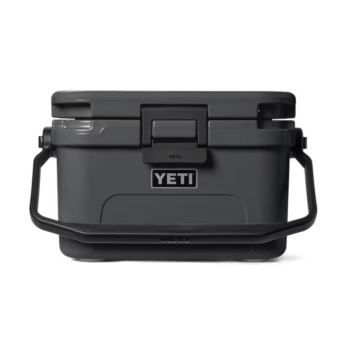 A dark gray YETI cooler with black handles and a black lid, shown from a front-facing perspective on a clean white background.