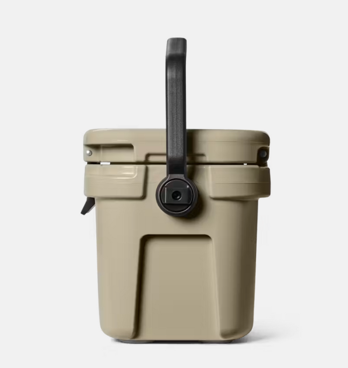 Tan cooler with black handle on a light gray background